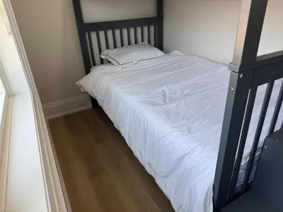 a bed with white sheets and a pillow on it at Downtown Toronto UFT in Toronto