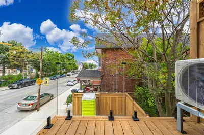 a house with a wooden deck in front of a street at Downtown Toronto UFT in Toronto