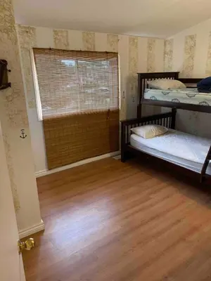 a room with two bunk beds and a window at Beautiful Four Bedroom Lagoon City Waterfront Home in Brechin