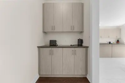 a kitchen with wooden cabinets and a counter top at Heaven Beach House 2 min walk in Georgina