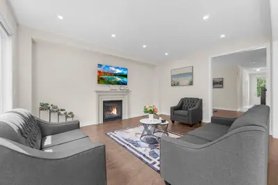 a living room with two couches and a fireplace at Heaven Beach House 2 min walk in Georgina