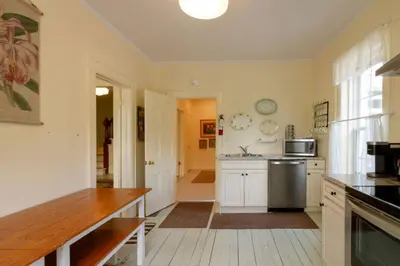 a kitchen with white cabinets and a refrigerator at Central Picton Apartment, Sleeps 8; The Iron Horse in Picton