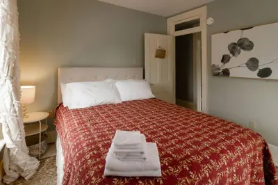 a bedroom with a bed with towels on it at Central Picton Apartment, Sleeps 8; The Iron Horse in Picton