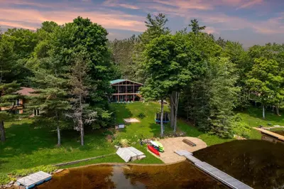 an aerial view of a house with a pond and trees at Muskoka Gem 8ppfireplacescanoekayaks in Bracebridge