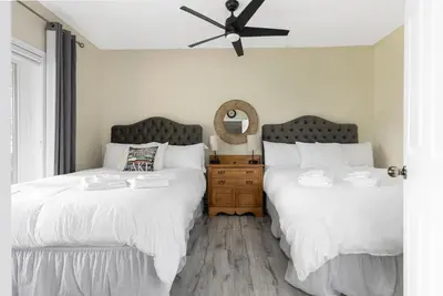 two beds sitting next to each other in a bedroom at Muskoka Gem 8ppfireplacescanoekayaks in Bracebridge