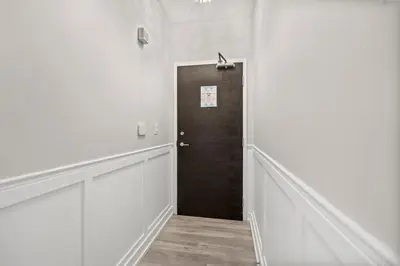 a hallway with a brown door in a white room at High Floor 1 Bedroom Condo Iceboat Terrace Downtown Toronto in Toronto