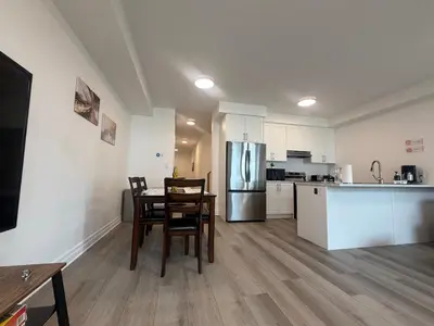 a kitchen and dining room with a table and chairs at Upscale Niagara Falls Getaway - BRAND NEW in Niagara Falls