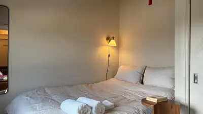 a bedroom with a bed with two towels on it at The Artist's Loft in Stratford