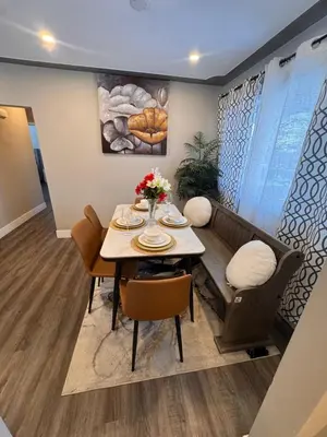 a dining room with a table and a couch at Luxe Living Prime Location in Kitchener