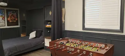 a bedroom with a chess board in a room at Modern Loft with Immersive Theatre Experience in Milton