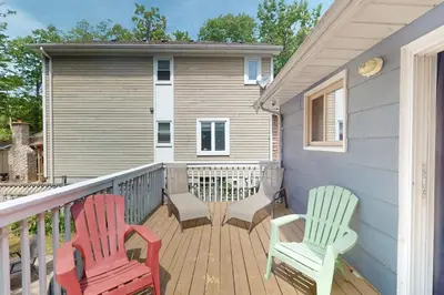 two chairs sitting on a deck in front of a house at Wavy Daze Master in Wasaga Beach