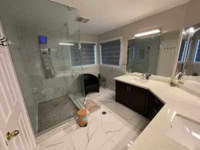 a large bathroom with a shower and a sink at Grandeur Homes in Whitby