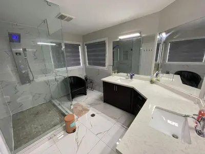 a bathroom with a shower and a sink and a tub at Grandeur Homes in Whitby