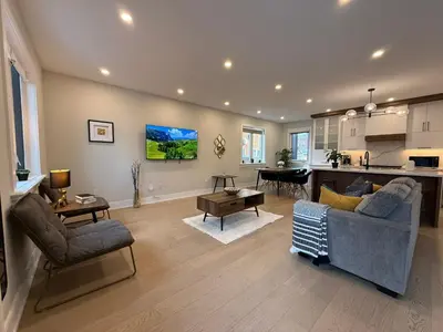 a living room with a couch and a kitchen at Prestige 3BR Luxury Living in Queen West in Toronto