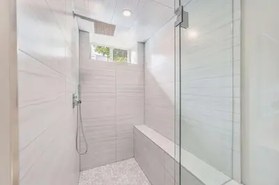a bathroom with a shower with a glass door at Stylish 1BR in Queen West in Toronto