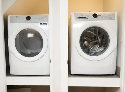 a washing machine and a dryer sitting on shelves at Stylish 1BR in Queen West in Toronto