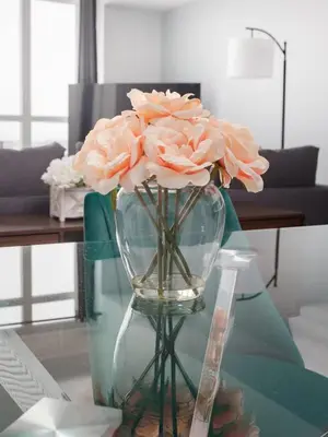 a vase filled with pink flowers on a glass table at Toronto Getaway 2BR Condo w City Views in Toronto