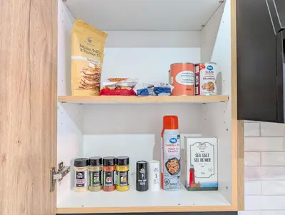 a kitchen pantry with food items on shelves at Hamilton Ontario 2 BR Wi-Fi Workspaces Near Ottawa in Hamilton