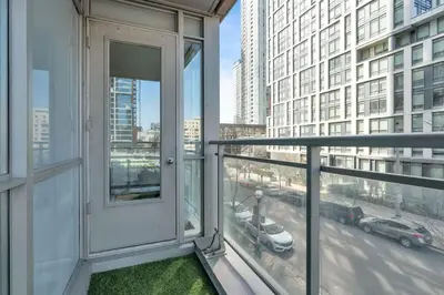 a balcony with a view of a city street at Modern Waterfront Comfort Condo with City Views in Toronto