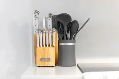 a container of kitchen utensils sitting on a counter at Modern & Stylish Comfort in the Heart of Toronto in Toronto
