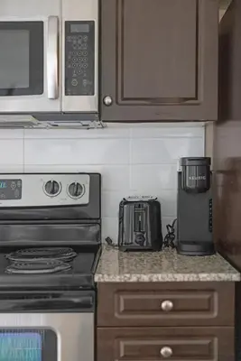 a kitchen with a microwave and a coffee maker on a counter at Cozy Waterfront Studio plus Parking by the Bentway in Toronto