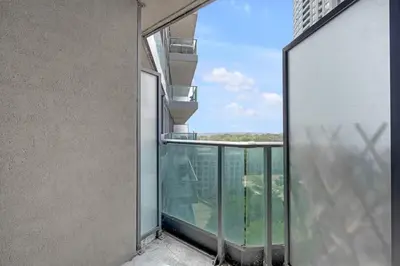 an open balcony with a view of a building at Cozy Waterfront Studio plus Parking by the Bentway in Toronto