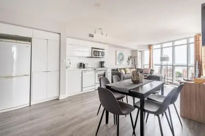 a kitchen and living room with a table and chairs at Corner 2 Bedroom 2 Bathroom Condo Balcony Iceboat Terrace Downtown Toronto in Toronto