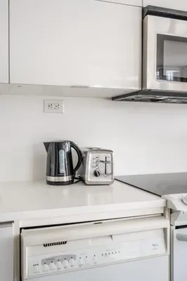 a coffee pot sitting on top of a kitchen counter at Corner 2 Bedroom 2 Bathroom Condo Balcony Iceboat Terrace Downtown Toronto in Toronto