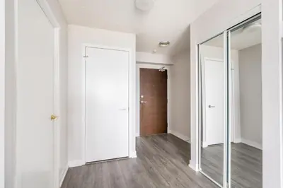 an empty hallway with white walls and a door at Corner 2 Bedroom 2 Bathroom Condo Balcony Iceboat Terrace Downtown Toronto in Toronto