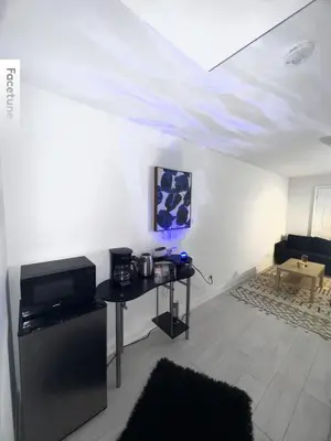 a living room with a table and a white ceiling at Entire unit seprate entrance in Richmond Hill