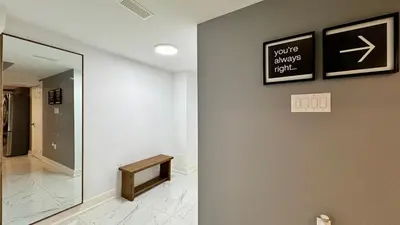a hallway with a mirror and a sign on a wall at Spacious and Luxurious 2BR Suite with Huge Windows in Mississauga