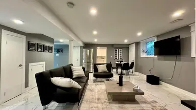 a living room with a couch and a table at Spacious and Luxurious 2BR Suite with Huge Windows in Mississauga
