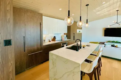 a kitchen with a large island with a counter top at Stoney Lake Cottage with Private Dock by Leavetown Vacations in Crowes Landing