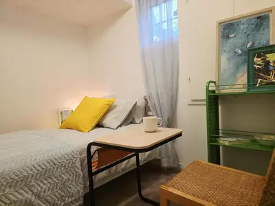 a small bedroom with a bed and a table at Semi-Private Townhouse - 3 Bedrooms - 4 beds - Free Parking, Wifi, Netflix in Toronto