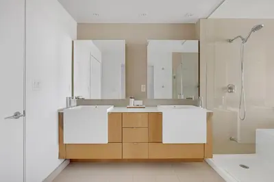 a bathroom with two sinks and a shower at Sky-High Penthouse Breathtaking City Views in Toronto