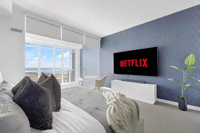 a bedroom with a bed and a tv on a wall at Sky-High Penthouse Breathtaking City Views in Toronto