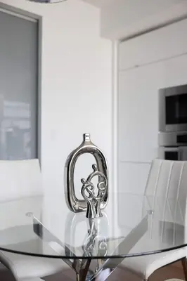 a glass table in a kitchen with two white chairs at Sky-High Penthouse Breathtaking City Views in Toronto