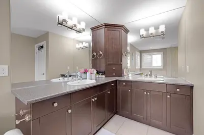 a bathroom with two sinks and a large mirror at Pool, King Bed, Patio with BBQ, Fall Hiking Nearby in Cambridge