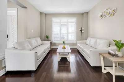 a living room with two white couches and a table at Pool, King Bed, Patio with BBQ, Fall Hiking Nearby in Cambridge