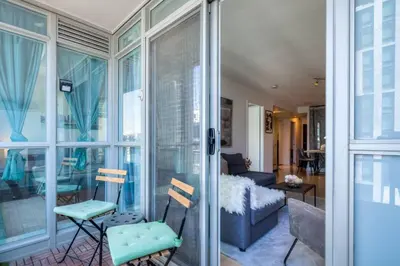 a living room with a sliding glass door at Modern 2 Bedroom plus Den Condo with Balcony Downtown Toronto in Toronto