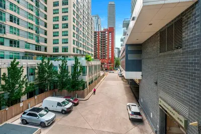 a city street with cars parked in front of buildings at New Modern 2 Bedroom 2 Bath Apartment with Balcony in Toronto