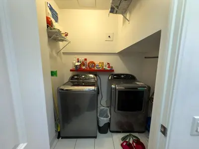 a small kitchen with two washers and a microwave at Luxury 2-Story loft in downtown in Toronto