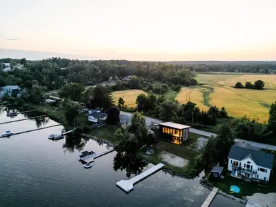 an aerial view of a house on a lake at Casa Luna Chic Lakehouse BBQ Game Room LakeViews in Orillia