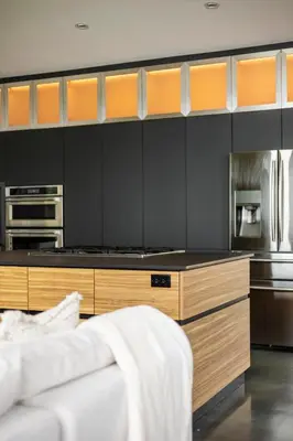 a kitchen with black walls and wooden cabinets at Casa Luna Chic Lakehouse BBQ Game Room LakeViews in Orillia