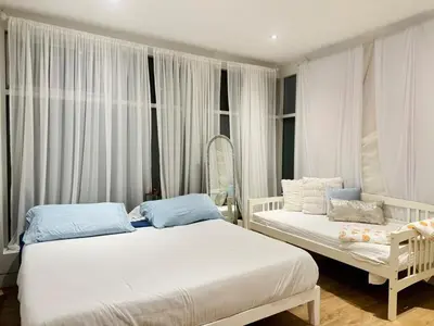 a bedroom with two beds and a mirror at Camden Haus Loft in Toronto