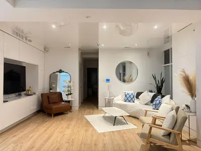 a living room with a couch and a chair at Camden Haus Loft in Toronto
