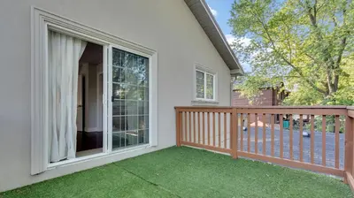 a balcony with a large window and green grass at Cozy Luxurious Villa in Toronto in Toronto