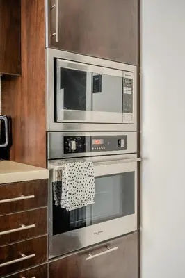 a kitchen with two ovens and a microwave at Modern 2Bd 2Ba Skyscraper Free parking in Toronto
