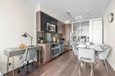 a kitchen and dining room with a table and chairs at luminous 2-Bedroom Apartment with Balcony in Toronto