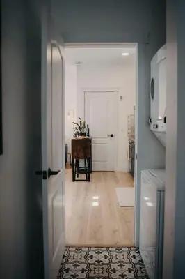 a hallway with a door open to a room with a table at The Hideout in Barrie